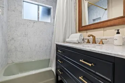 a bathroom with a sink and a bath tub and a sink at River Haus Sequoia | Hot Tub+New+King Beds+Views! in Springville