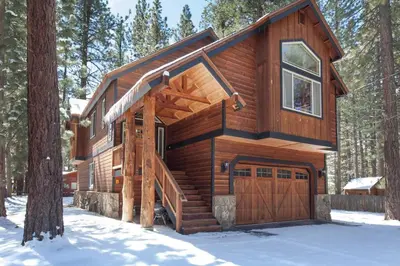 a log cabin in the woods in the snow at Luxury Home Near Lake, Heavenly, Casinos in South Lake Tahoe