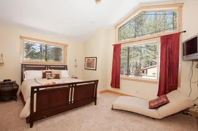 a bedroom with a bed and a large window at Luxury Home Near Lake, Heavenly, Casinos in South Lake Tahoe