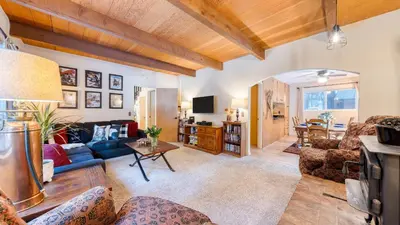 a living room with a couch and a table at Mountain Cabin w Fireplace Balcony Easy Ski Access Bear Americana in Truckee