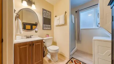 a bathroom with a toilet and a sink and a mirror at Mountain Cabin w Fireplace Balcony Easy Ski Access Bear Americana in Truckee
