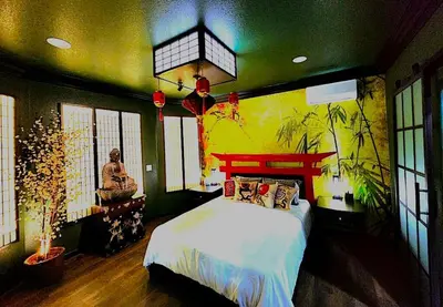 a bedroom with a bed and a painting on the wall at Asian Zen Den in Sparks