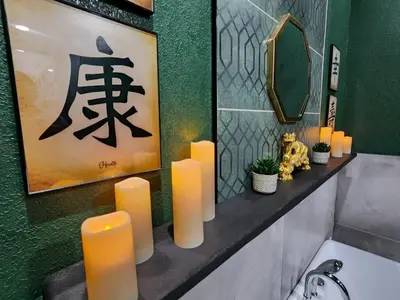 a bathroom with candles on a counter with a mirror at Asian Zen Den in Sparks