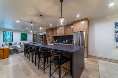 a kitchen with a large island with bar stools at Spectacular New 4BR Townhome: Garage, Jacuzzi, BBQ in Mammoth Lakes