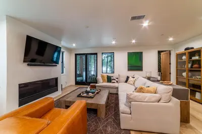 a living room with a couch and a tv at Spectacular New 4BR Townhome: Garage, Jacuzzi, BBQ in Mammoth Lakes