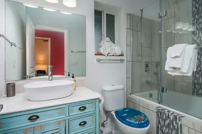 a bathroom with a sink and a toilet and a shower at Yosemite Gateway Sleeps 18 - Coarsegold Villa near Bass Lake in Coarsegold