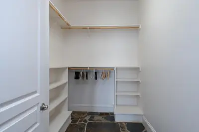 a walk in closet with white walls and shelves at Yosemite Gateway Sleeps 18 - Coarsegold Villa near Bass Lake in Coarsegold