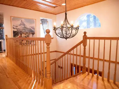 a staircase in a home with a chandelier at Mountain Retreat near Skiing, HotTub, PetFriendly in Tahoe City