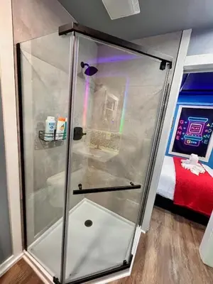a shower with a glass door in a room at GameZone in Sparks