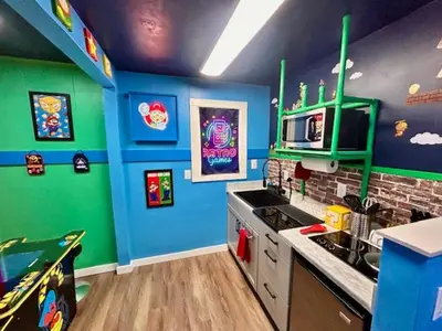 a kitchen with blue and green walls at GameZone in Sparks