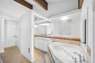 a white bathroom with a tub and a sink at Remodeled 4BR Lakefront with Exceptional Amenities in Kings Beach