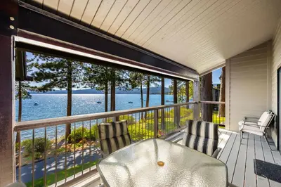a porch with two chairs and a view of the water at Remodeled 4BR Lakefront with Exceptional Amenities in Kings Beach