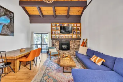 a living room with a blue couch and a table at Alpine Retreat in the Heart of Incline Village condo in Incline Village