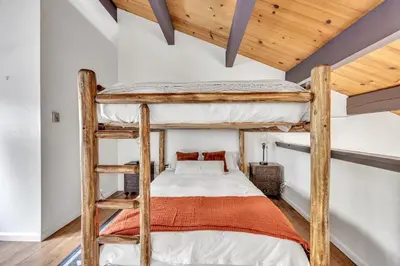 a bedroom with two bunk beds and wooden ceilings at Alpine Retreat in the Heart of Incline Village condo in Incline Village
