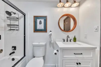 a bathroom with a toilet and a sink and a mirror at Alpine Retreat in the Heart of Incline Village condo in Incline Village