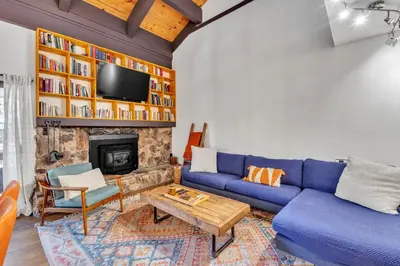 a living room with a blue couch and a fireplace at Alpine Retreat in the Heart of Incline Village condo in Incline Village