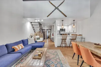 a living room with a blue couch and a table at Alpine Retreat in the Heart of Incline Village condo in Incline Village