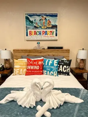 a bed with two swans made out of towels at Beach House Staycation in Sparks