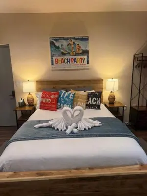 a bedroom with a bed with two swans on it at Beach House Staycation in Sparks