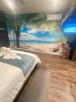 a bedroom with a mural of a beach at Beach House Staycation in Sparks