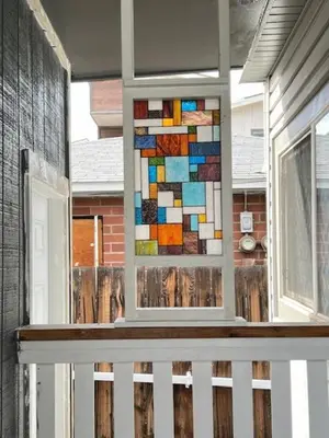 a stained glass window on a porch of a house at MidTown Art Deco in Reno