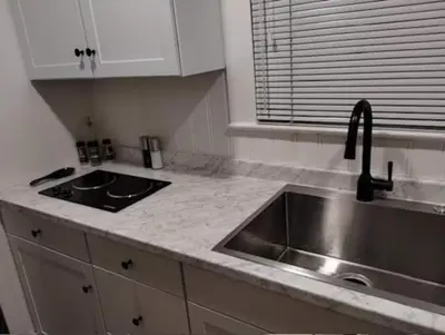 a kitchen with a sink and a counter top at MidTown Art Deco in Reno