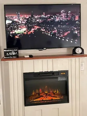 a fireplace with a flat screen tv above it at MidTown Art Deco in Reno
