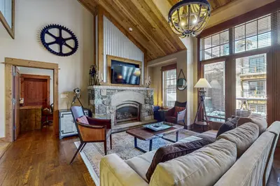 a living room with a couch and a fireplace at Northstar Escape + Northstar Getaway in Truckee