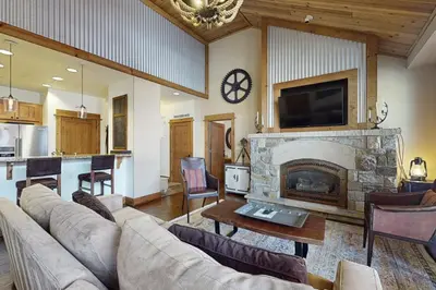 a living room with a couch and a fireplace at Northstar Escape + Northstar Getaway in Truckee