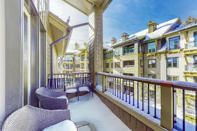 a balcony with chairs and some buildings at Northstar Escape + Northstar Getaway in Truckee