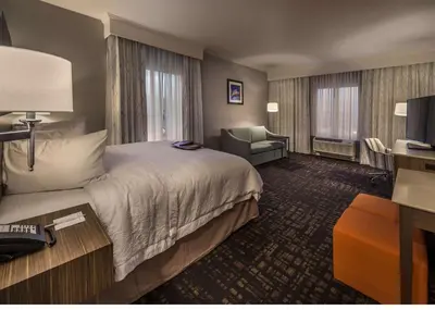 a hotel room with a bed and a chair at Hampton Inn & Suites - Reno West, NV in Reno
