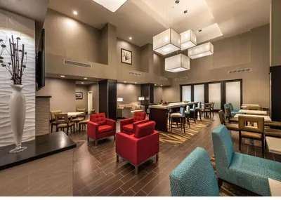 a restaurant with red chairs and tables and a lobby at Hampton Inn & Suites - Reno West, NV in Reno