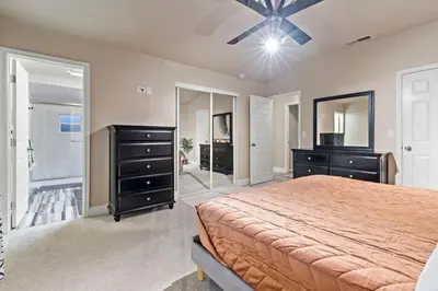 a bedroom with a bed and a dresser and a mirror at Huge House-Yard-Pool Hot Tub in Citrus Heights