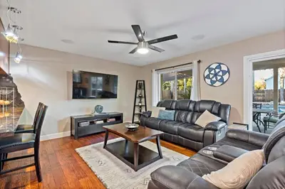 a living room with a couch and a table at Huge House-Yard-Pool Hot Tub in Citrus Heights