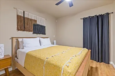 a bedroom with a large bed and a window at Huge House-Yard-Pool Hot Tub in Citrus Heights
