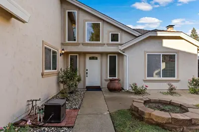 a white house with a tv in the front yard at Huge House-Yard-Pool Hot Tub in Citrus Heights