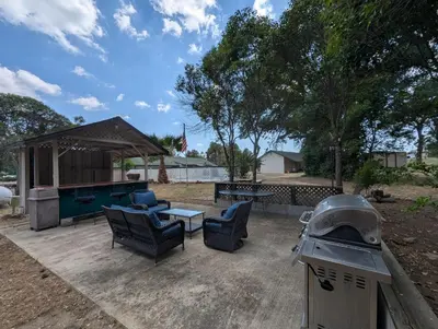 a backyard with a pool table and chairs and a grill at Squaw Valley Motel Room 6 in Squaw Valley