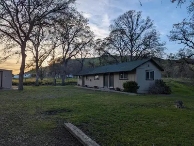 a house in the middle of a yard at Squaw Valley Motel Room 4 in Squaw Valley