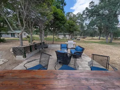 a patio with a table and chairs and trees at Squaw Valley Motel Room 8 in Squaw Valley