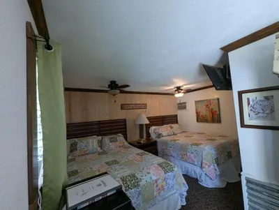 a bedroom with two beds and a ceiling fan at Squaw Valley Motel Room 7 in Dunlap