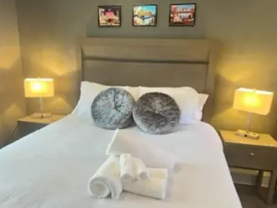 a bedroom with a white bed with two pillows on it at Reno Romantic Couples Retreat in Reno