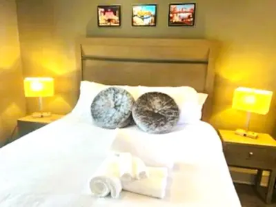 a bedroom with a white bed with two pillows on it at Reno Romantic Couples Retreat in Reno