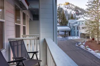 a chair sitting on the porch of a house at Palisades Tahoe Lodge Rentals Premium Fireplace One Bedroom #807 in Olympic Valley