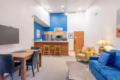 a living room with a couch and a table at Palisades Tahoe Lodge Rentals Premium Fireplace One Bedroom #807 in Olympic Valley