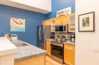 a kitchen with stainless steel appliances and blue walls at Palisades Tahoe Lodge Rentals Premium Fireplace One Bedroom #807 in Olympic Valley
