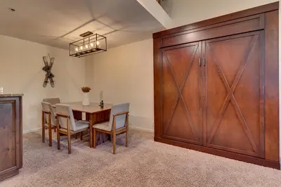 a dining room with a table and a sliding barn door at Palisades Tahoe Lodge Rentals Premium Studio Loft #358 in Olympic Valley