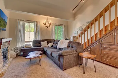 a living room with a couch and a fireplace at Palisades Tahoe Lodge Rentals Premium Studio Loft #358 in Olympic Valley