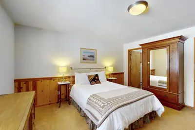 a bedroom with a bed and a large mirror at North Shore Escape in Carnelian Bay