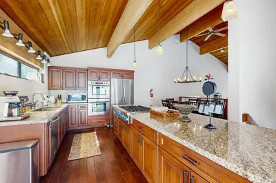 a large kitchen with wooden cabinets and granite counter tops at Northstar Paradise in Ponderosa Fairway Estates