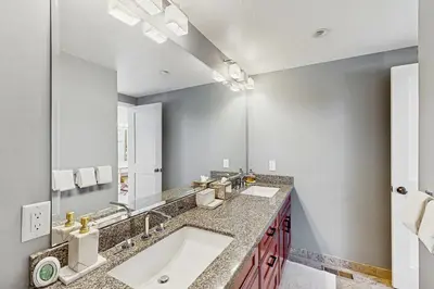 a bathroom with a sink and a large mirror at Northstar Paradise in Ponderosa Fairway Estates